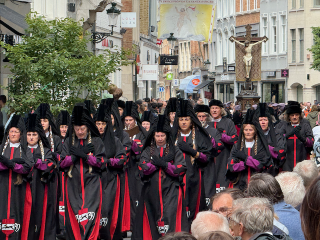 A procession leading the crusified Jesus