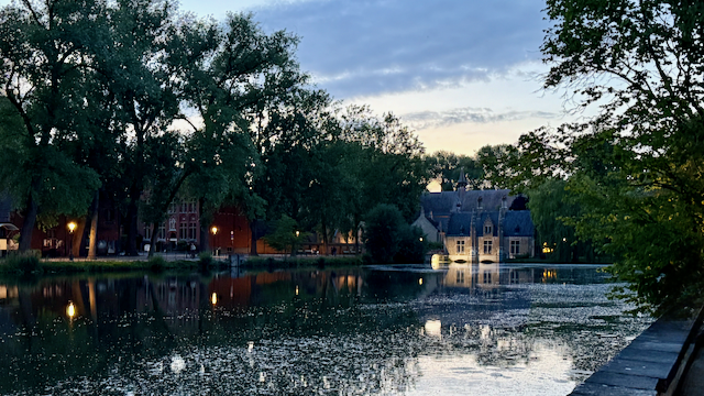 Dusk falling over Minnewater—soft light, still water, and quiet wonder.