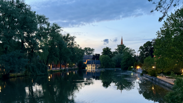 Evening deepens on the Lake of Love—Bruges quietly catching its breath under the cathedral’s watchful eye.