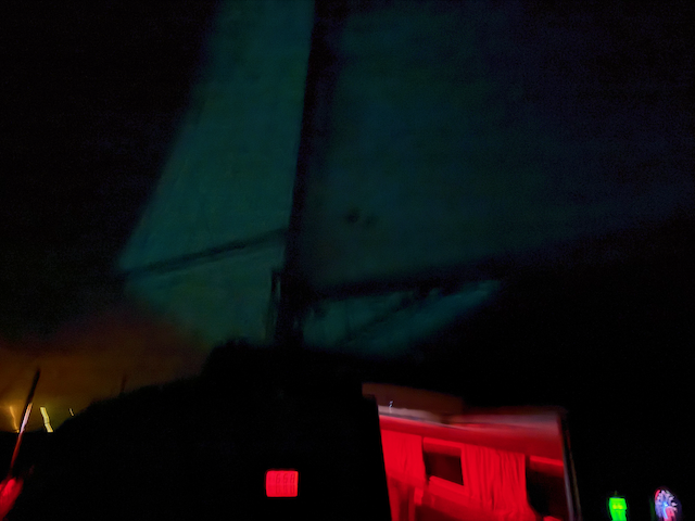 Ghostly spinakker at night.