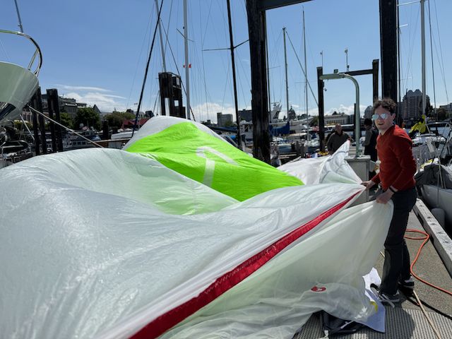 James rinsing and folding the spinaker