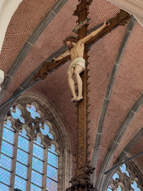 Suspended in stillness—this haunting crucifix floats above the choir in the Church of Our Lady in Bruges, a solemn reminder of faith carved in wood and shadowed by centuries of prayer.