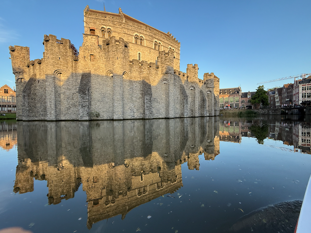 The mighty Gravensteen—Ghent’s medieval stronghold, once home to the Counts of Flanders and now a dramatic reminder of the city’s feudal past, surrounded by a mirror-still moat at golden hour