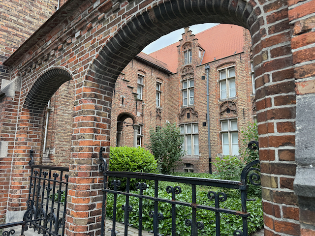 Through the arches of time — a quiet courtyard inside Bruges’ Sint-Janshospitaal, where centuries of care, devotion, and healing echo softly among the bricks.