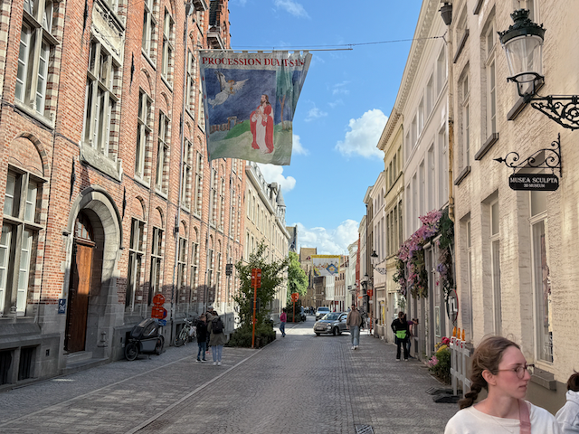Walking the sacred path- Bruges dresses up in medieval splendor for the Procession of the Holy Blood. The banners, flower-draped facades, and hushed cobblestones echo centuries of devotion and drama.